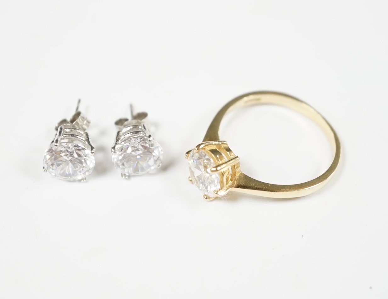 A modern 14k and solitaire simulated diamond set ring, size Q/R, gross 3.6 grams, together with a pair of white metal and simulated diamond set ear studs. Condition - fair